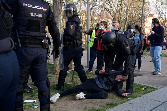 Police detain a person during a demonstration against a political rally of far-right party Vox ahead of regional elections in Madrid's suburb of Vallecas on April 7, 2021. (Photo by JAVIER SORIANO / AFP) (Photo by JAVIER SORIANO/AFP via Getty Images)
