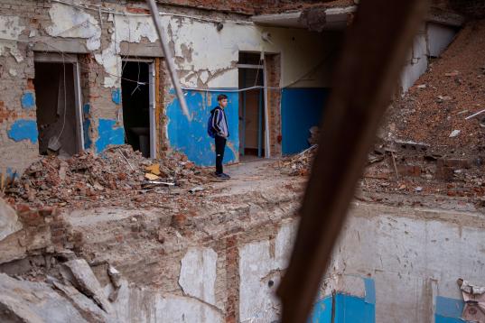 Mykola Kravchenko, de 12 años, mira su destrozada aula de informática en el liceo Mykhailo-Kotsyubynske. “Cuando estoy en la escuela, pienso en la persona que murió entre los escombros. Lo siento profundament...