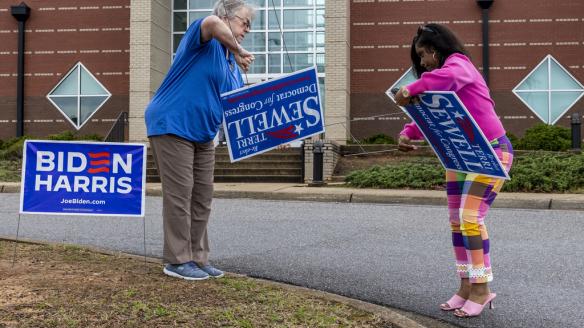 Votantes demócratas colocan carteles de la campaña de Biden en Alabama