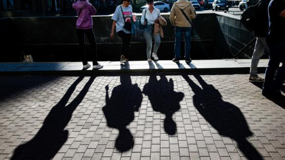 La sombra de los peatones se proyectan sobre la acera de una calle de San Petersburgo.