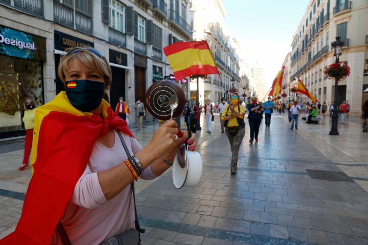 MALAGA, SPAIN - MAY 21: A woman with a saucepan and a Spanish flag is seen at Larios street in a protest against the Government's management of the coronavirus crisis on May 21, 2020 in Malaga, Spain. (Photo by Álex Zea/ Europa Press via Getty ...