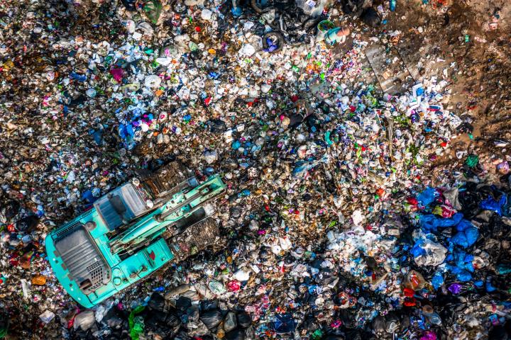 Garbage pile  in trash dump or landfill, Aerial view garbage trucks unload garbage to a landfill,  global warming.