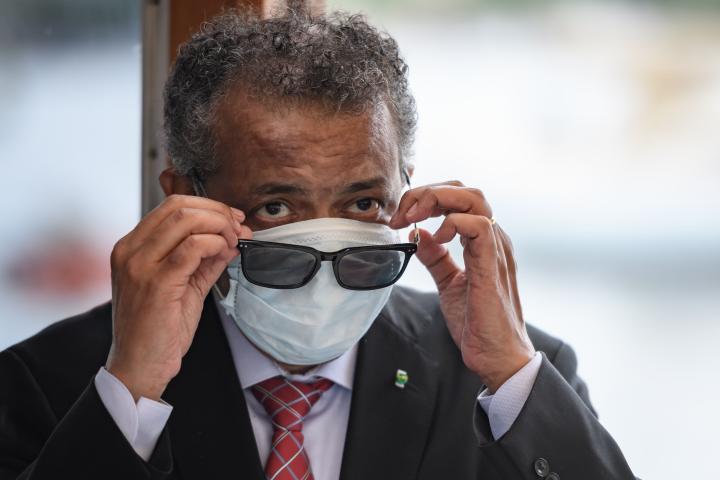 World Health Organization (WHO) Director-General Tedros Adhanom Ghebreyesus wears a mask after leaving a ceremony of the restarting of Geneva's landmark fountain, known as "Jet d'Eau" following the COVID-19 outbreak, caused by the novel coronavi...
