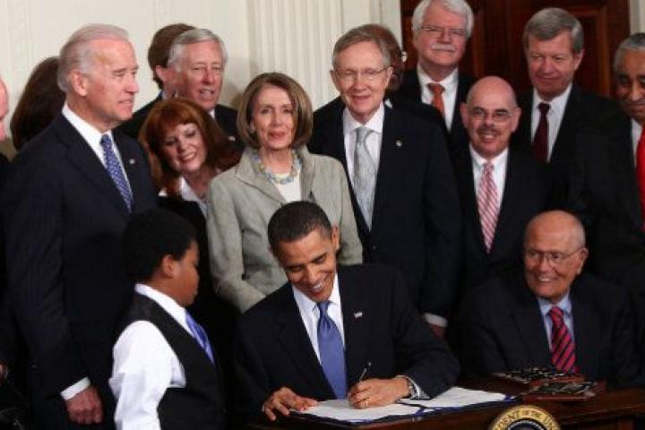 WASHINGTON - MARCH 23:  U.S. President Barack Obama signs the Affordable Health Care for America Act during a ceremony with fellow Democrats in the East Room of the White House March 23, 2010 in Washington, DC. The historic bill was passed by th...
