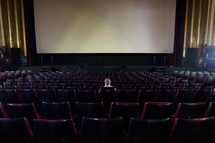 MADRID, SPAIN - JUNE 12: A man waits for the beginning of the film in the Capitol cinema on June 12, 2020 in Madrid, Spain. The Capitol cinema reopens with a 20% capacity in each of its screening rooms after its closure in the middle of March, b...