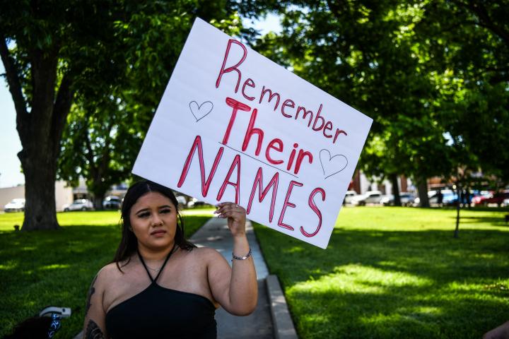 Una mujer sostiene una pancarta en la que pide recordar los nombres de los niños asesinados en una escuela en Uvalde, Texas.