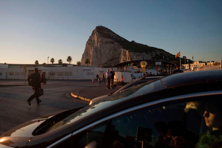 People cross the border of the British overseas territory of Gibraltar on October 17, 2018. - Gibraltar has close to full employment and it has long been a lifeline for people who live in the adjacent area of Spain known as 'El Campo de Gibralta...