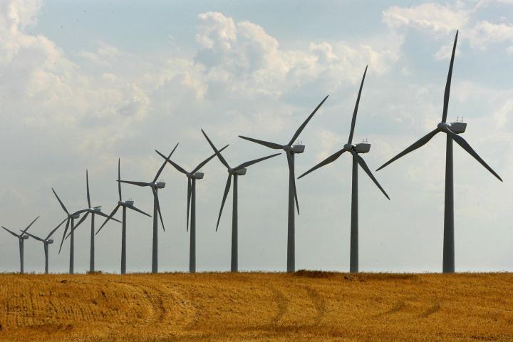 Giant wind turbines are seen in a dry field at Los Monegros in Aragon, Spain July 1, 2005. A severe drought in Spain, the worst since the 1970s, has sparked forest fires and is threatening millions of tourists with water rationing as they head f...