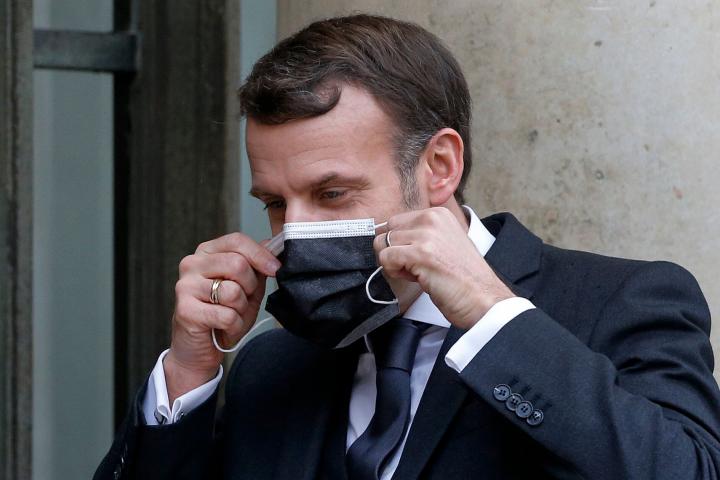 PARIS, FRANCE - FEBRUARY 03: French President Emmanuel Macron adjusts his protective face mask as he welcomes Slovakia's Prime Minister Igor Matovic prior to a working lunch at the Elysee Palace on February 3, 2021 in Paris, France. Igor Matovic...
