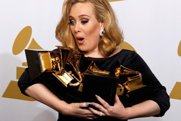 Singer Adele holds her six Grammy Awards at the 54th annual Grammy Awards in Los Angeles, California February 12, 2012. Soul singer Adele triumphed in her return to music's stage on Sunday, scooping up six Grammys and winning every category in w...