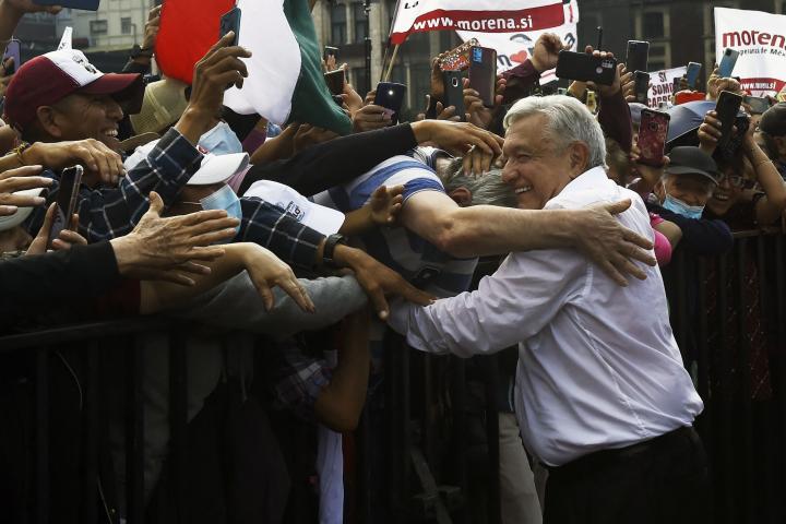López Obrador saluda a uno de sus seguidores en la marcha por Ciudad de México