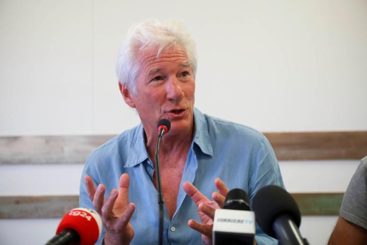 Actor Richard Gere gestures as he speaks during a press conference he held along with Open Arms founder Oscar Camps, in the island of Lampedusa, Southern Italy, Saturday, Aug. 10, 2019, the day after he visited the Spanish humanitarian ship that...