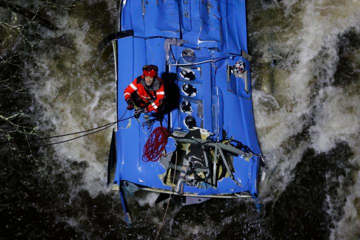 Los bomberos trabajan en el rescate de víctimas del autobús que se precipitó al río Lérez, tras caer de un puente,  en Pontevedra.