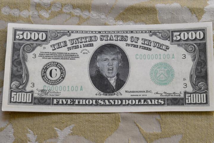 HENDERSON, NEVADA - MAY 07:  A prop USD 5,000 bill is displayed in the makeup room of actor, comedian and writer John Di Domenico as he gets ready to record videos as U.S. President Donald Trump for the Cameo personalized message website on a Wh...