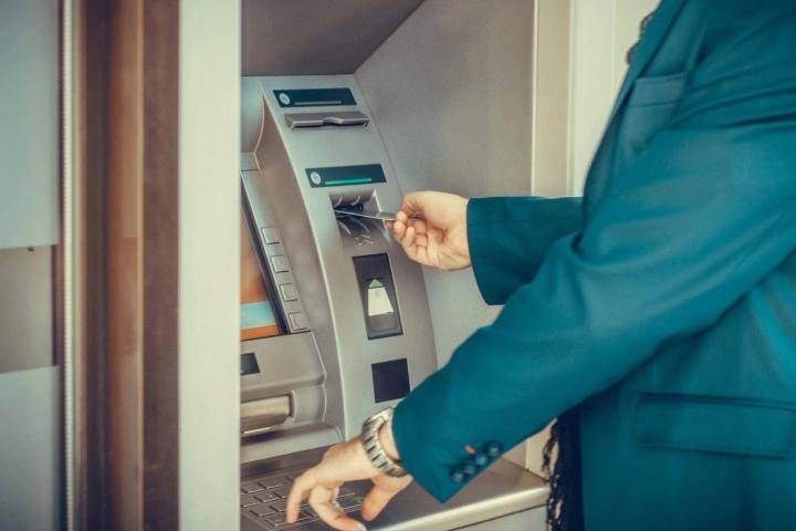 Una persona saca dinero en un cajero automático