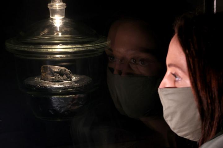 Una mujer echa un vistazo a uno de los restos del meteorito Winchcombe en el Museo de Historia Natural en Londres