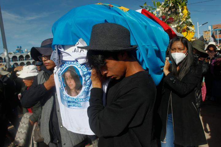 Relatives and friends attend the burial of 17-year-old student Jamilath Aroquipa, one of the 17 deceased during the violent attempt to take over the airport of the city of Juliaca on January 9, at the Capilla cemetery in Juliaca, southern Peru, on January 12, 2023. - Street barricades and marches against the government continued in Peru on Thursday as mourners prepared to bury the bodies of 17 people killed during clashes between security forces and demonstrators in the movement's epicenter. (Photo by Juan Carlos CISNEROS / AFP) (Photo by JUAN CARLOS CISNEROS/AFP via Getty Images)