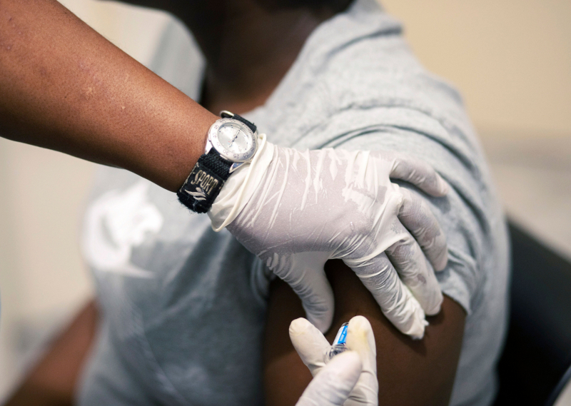 Sisi Ndebele, receives a seasonal influenza vaccine from a nurse at a local pharmacy clinic in Johannesburg, South Africa at 1800 on Friday, April 24, 2020. (AP Photo/Themba Hadebe)
